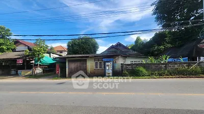 Charming rural property with lush greenery and traditional architecture.