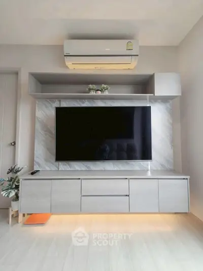 Modern living room with sleek TV unit and air conditioning