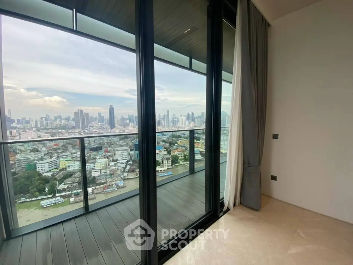 Stunning high-rise apartment with panoramic city view from a spacious balcony.