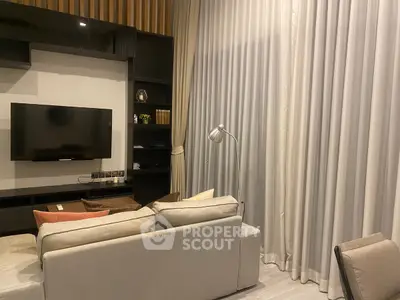 Modern living room with cozy sofa and wall-mounted TV, perfect for relaxation.