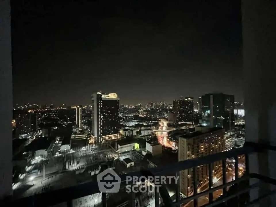 Stunning cityscape night view from high-rise balcony, showcasing vibrant urban lights and skyline.