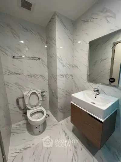 Modern bathroom with sleek marble tiles and contemporary fixtures