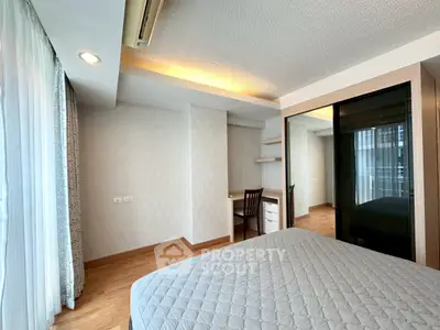 Modern bedroom with stylish decor and ample natural light in a contemporary apartment.