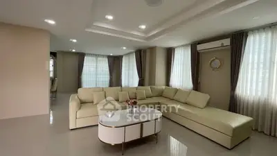 Spacious modern living room with elegant beige sectional sofa and stylish decor