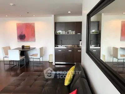 Modern living room with sleek kitchenette and stylish decor