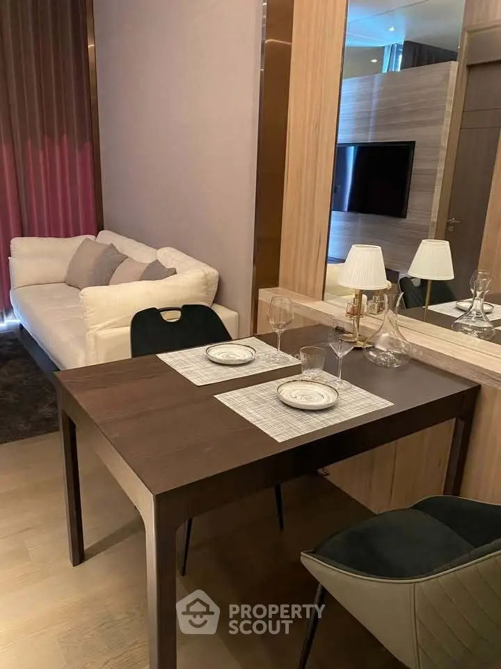 Modern living room with elegant dining setup and cozy sofa, perfect for urban living.