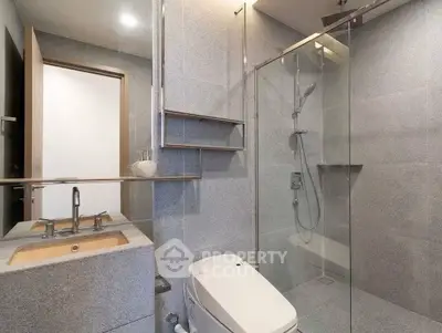 Modern bathroom with sleek shower and elegant fixtures in a contemporary apartment.