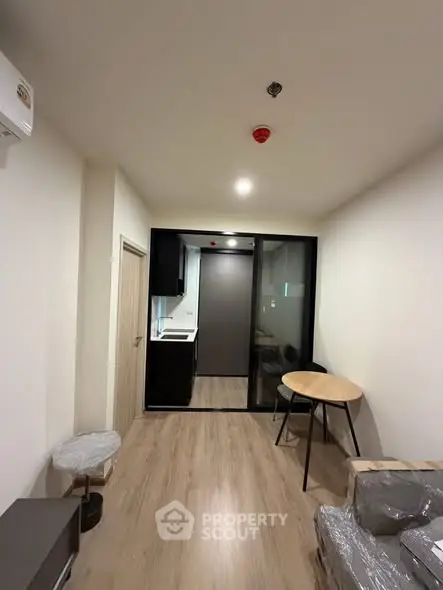Modern apartment interior with open layout and sleek kitchen design.