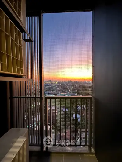Stunning sunset view from a high-rise balcony with cityscape panorama.