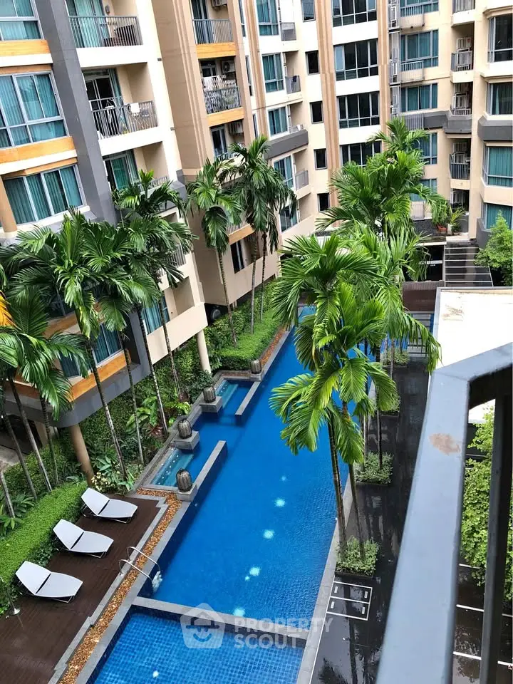 Luxurious apartment complex with a stunning pool and lush greenery, perfect for relaxation and leisure.