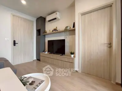 Modern living room with sleek wooden flooring and stylish TV unit