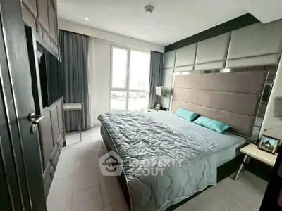 Modern bedroom with large window and stylish decor in a contemporary apartment.