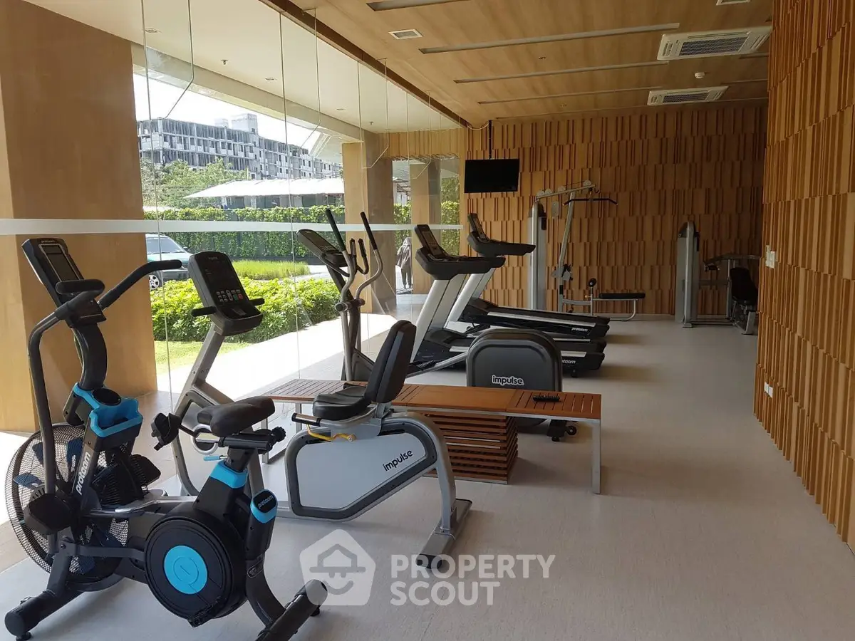Modern gym with state-of-the-art equipment and scenic outdoor view