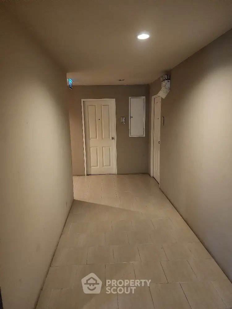 Spacious and well-lit entryway with neutral tones and tiled flooring, offering a welcoming entrance to a modern home.