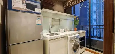 Modern kitchen with sleek appliances and city view from balcony