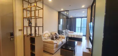 Modern living room with glass partition and cozy bedroom view