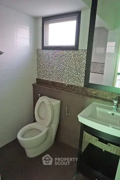 Modern bathroom with mosaic tiles and sleek fixtures