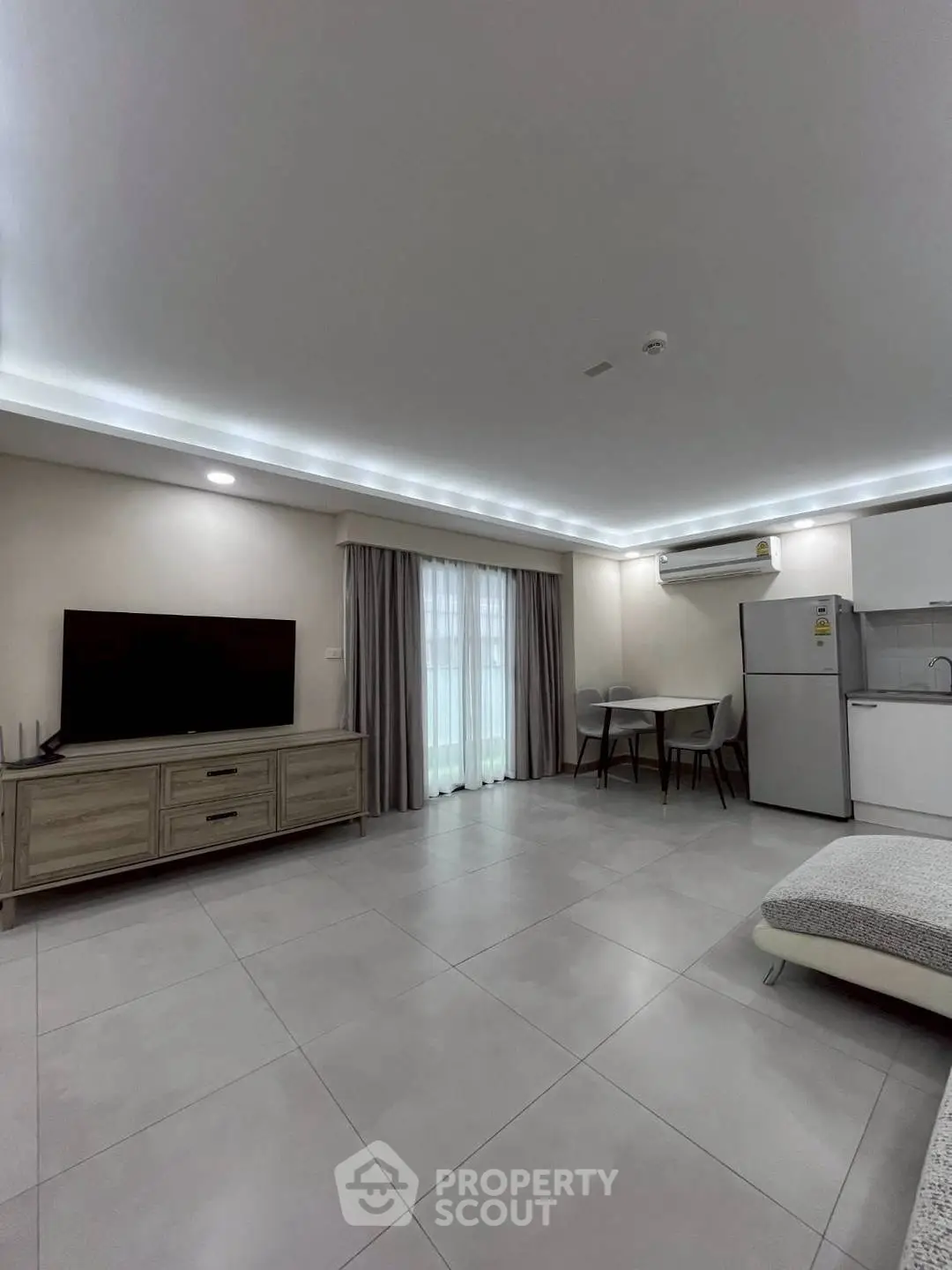 Modern living room with sleek furniture and open kitchen layout