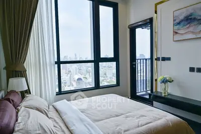 Luxurious bedroom with stunning city view and private balcony access.