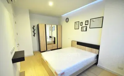 Modern bedroom with stylish wooden furniture and wall decor