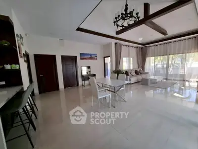 Spacious modern living room with elegant decor and large windows for natural light.