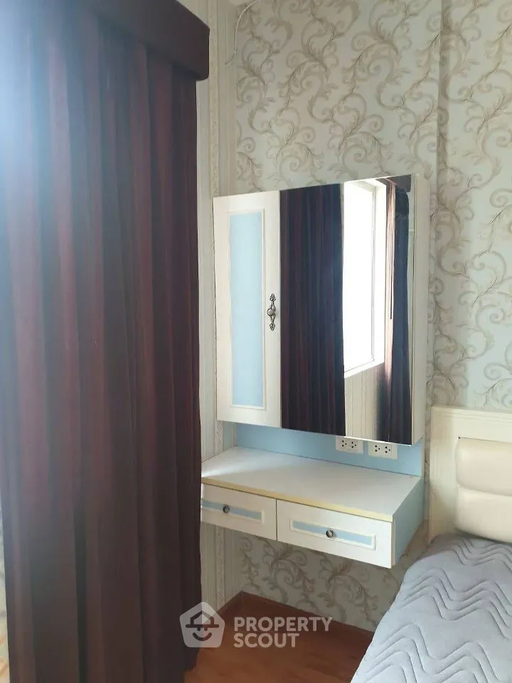 Charming bedroom with elegant wallpaper and stylish vanity mirror