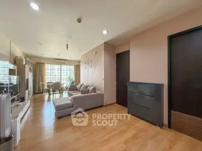 Spacious modern living room with wooden flooring and stylish furniture