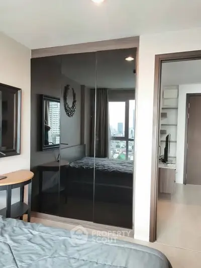 Modern bedroom with city view and sleek mirrored wardrobe