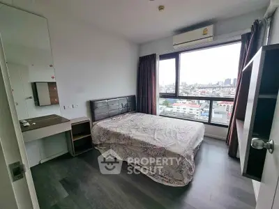 Modern bedroom with city view, featuring a cozy bed, sleek flooring, and ample natural light.