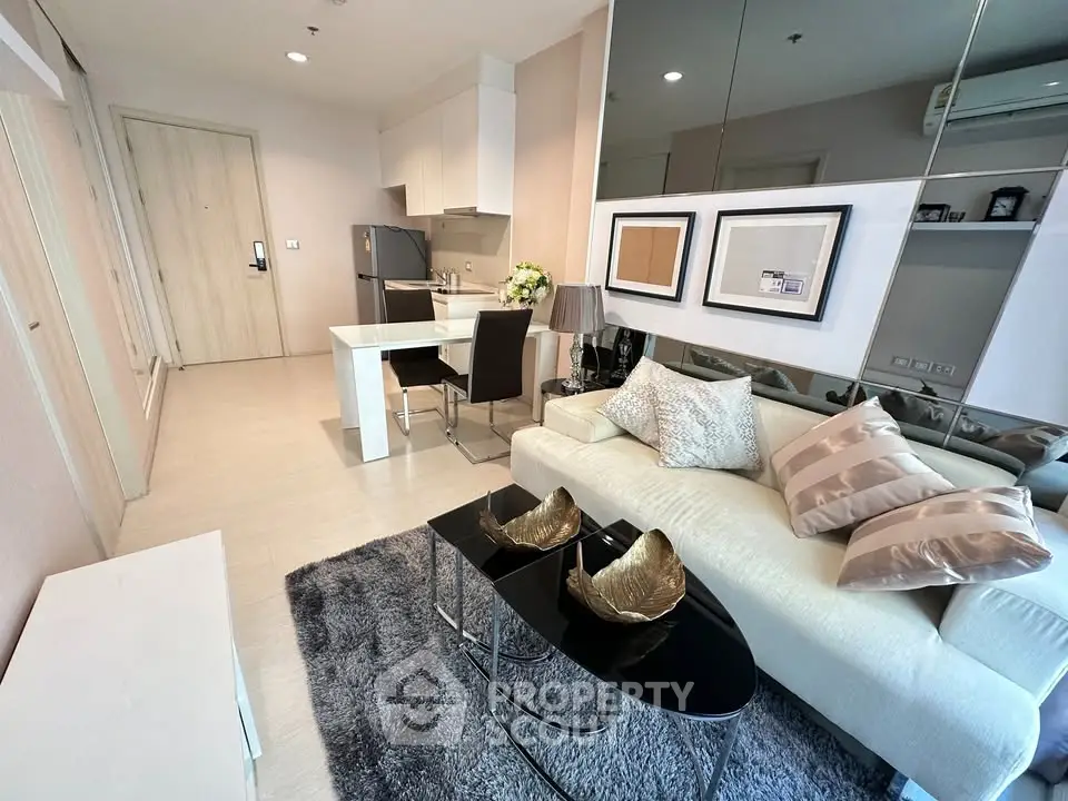 Modern living room with stylish decor and open kitchen layout in a chic apartment.