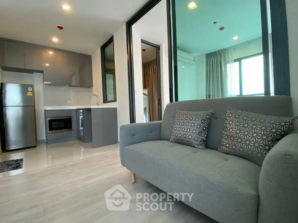Modern open-layout apartment with sleek kitchen and cozy living area
