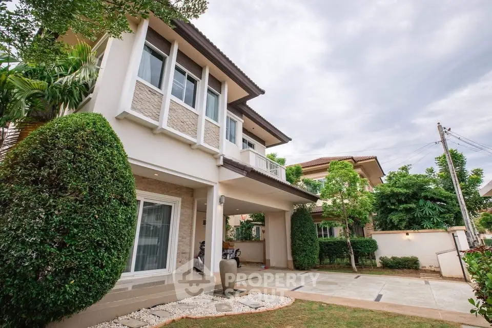 Stunning two-story house with landscaped garden and spacious driveway in a serene neighborhood.