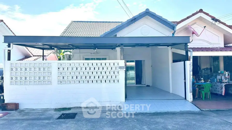 Charming single-story home with covered carport and tiled entrance in a peaceful neighborhood.