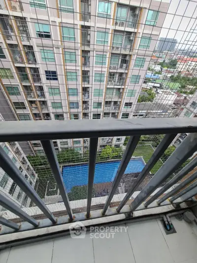 High-rise apartment balcony with pool view and cityscape
