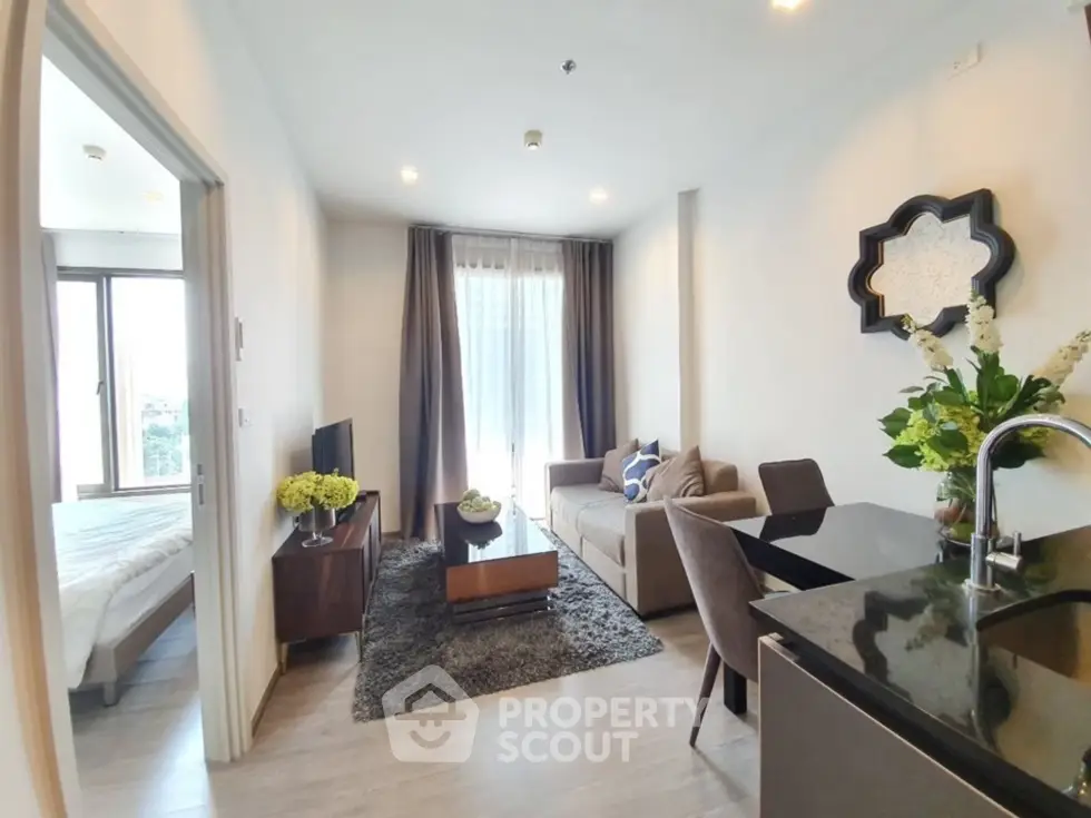 Modern living room with open layout, stylish furniture, and natural light in a contemporary apartment.