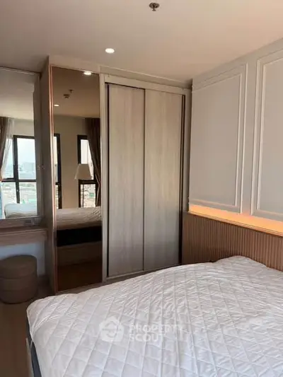 Modern bedroom with large windows and stylish decor in a high-rise apartment.