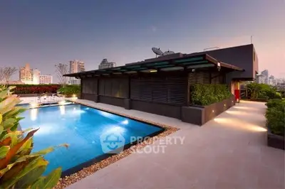 Luxurious rooftop pool with stunning cityscape views at sunset, perfect for relaxation and entertainment.