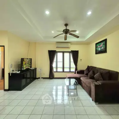 Spacious living room with modern decor and large sectional sofa.