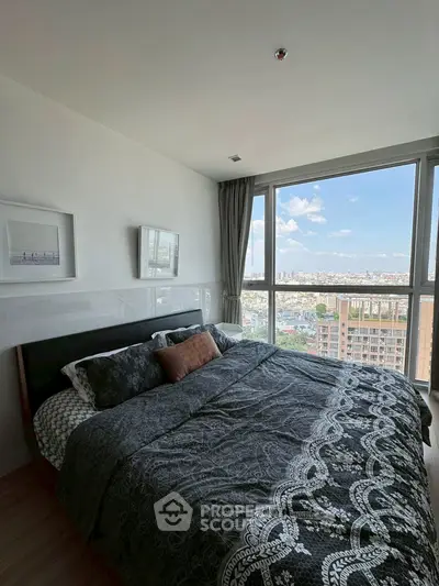 Luxurious bedroom with stunning city view and elegant decor in modern high-rise apartment.