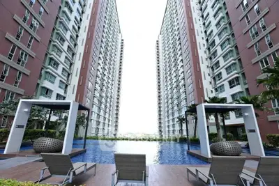 Luxurious apartment complex with stunning pool and modern architecture.