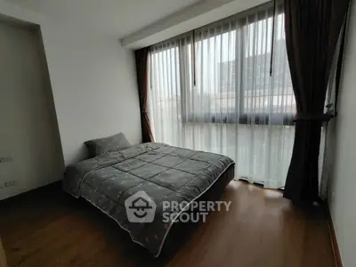 Cozy bedroom with large window and modern decor