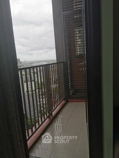 High-rise balcony with city view and overcast sky, perfect for urban living.