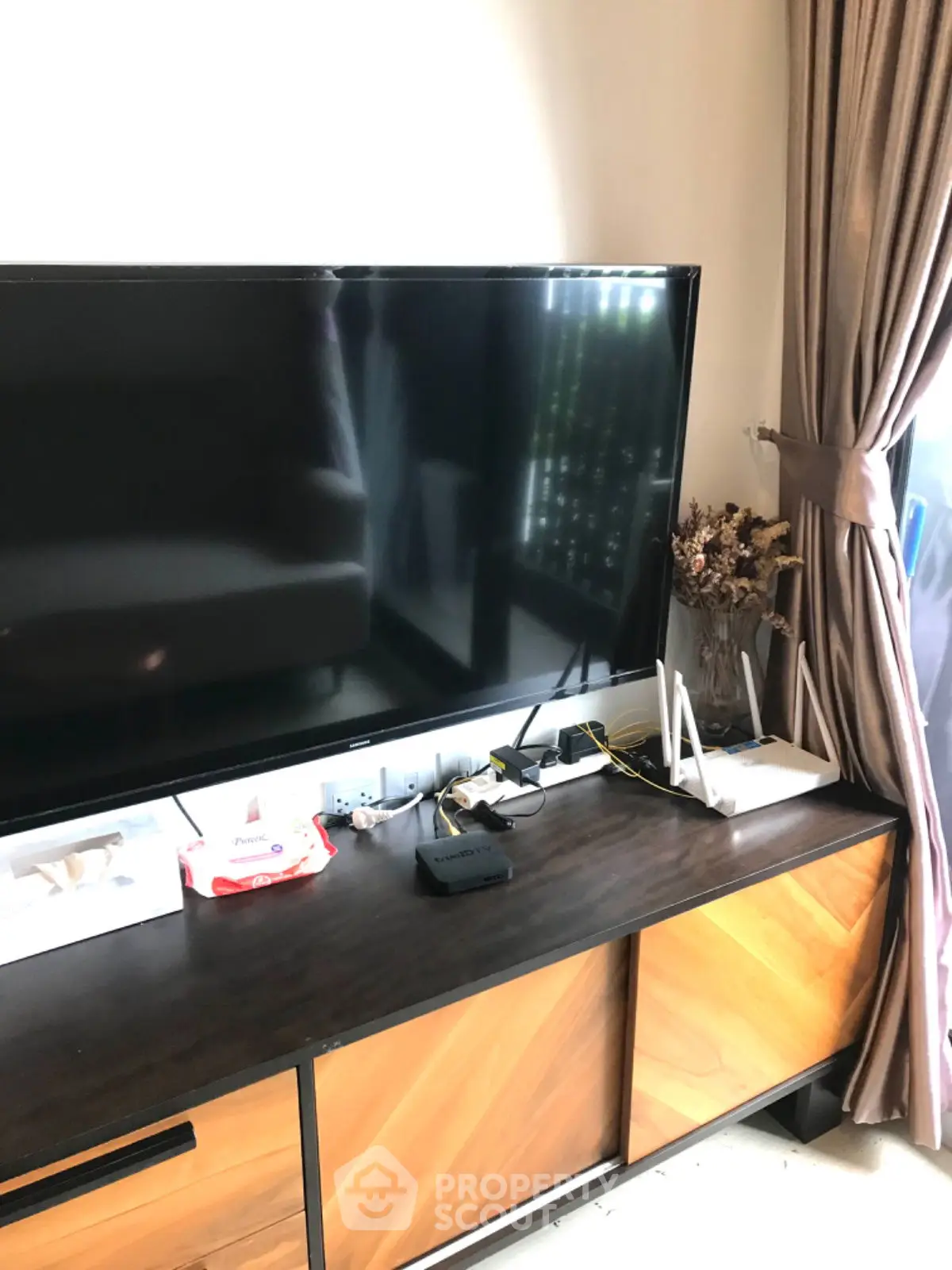 Modern living room with sleek TV setup and stylish wooden cabinet