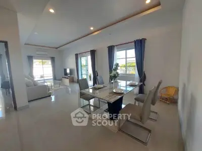 Spacious modern living and dining area with elegant decor and natural light.