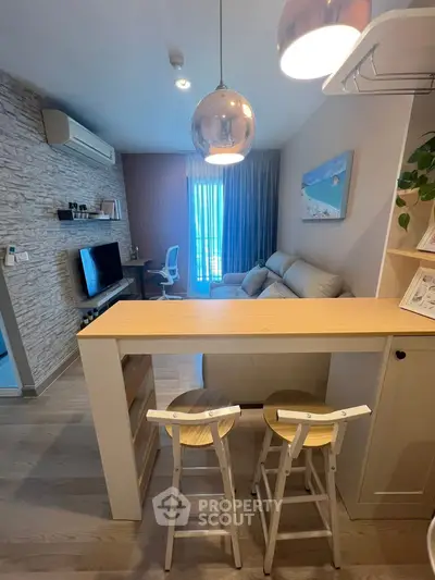 Modern living room with stylish decor and open layout, featuring a cozy seating area and elegant lighting.