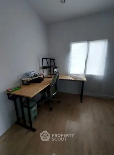 Cozy study room with wooden desk and chair, perfect for productivity.