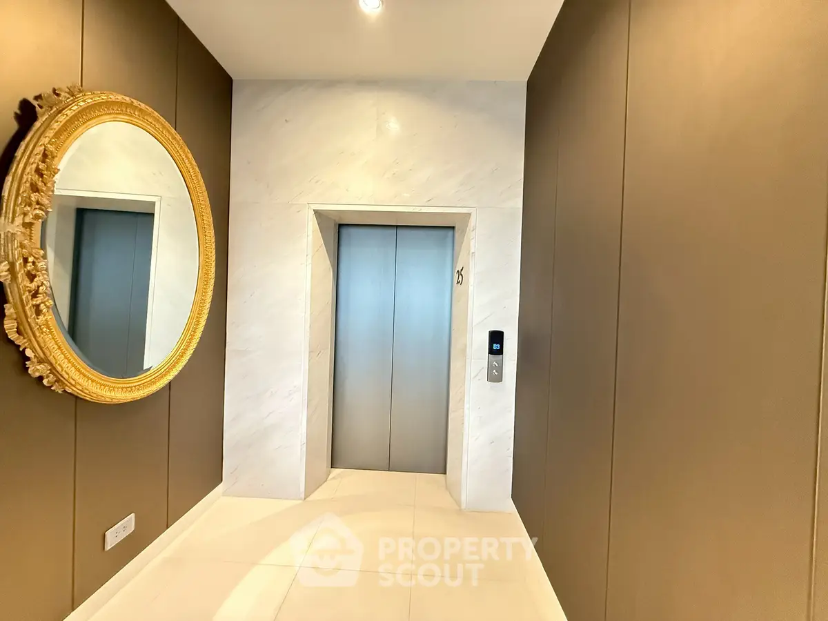 Luxurious modern elevator lobby with elegant decor and golden mirror