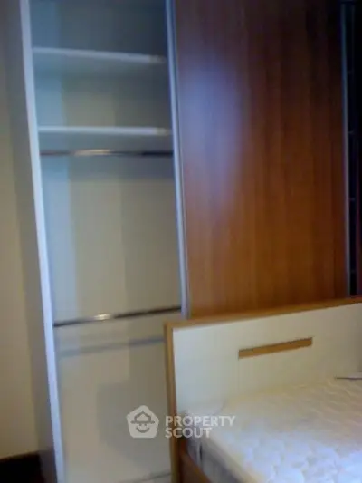 Spacious bedroom with built-in wardrobe and comfortable bed frame.