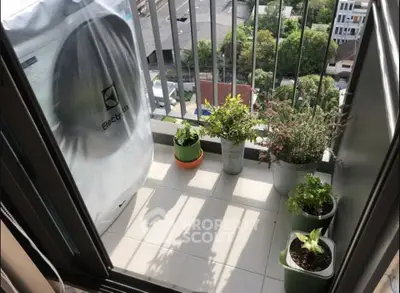 Charming balcony with potted plants and city view, perfect for relaxation.