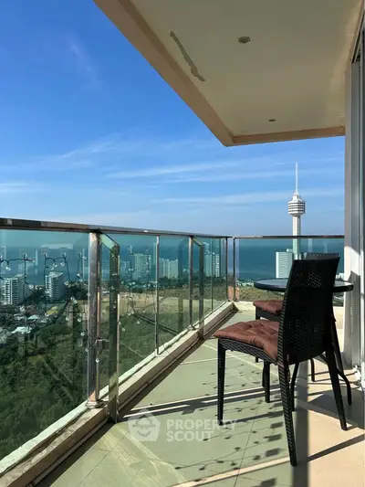 Stunning balcony view with ocean and cityscape, perfect for relaxation and enjoying the skyline.